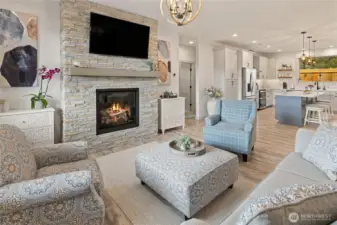 Entering through the front door, you’re welcomed into a bright, open-concept living room that flows seamlessly into the kitchen, creating an inviting and connected main living space.