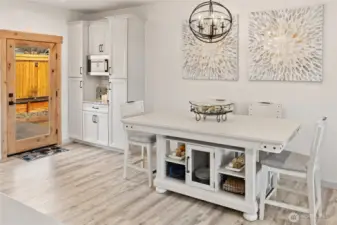 Back inside, the charming coffee/wine bar area is perfectly positioned for both indoor and outdoor entertaining, offering a convenient and stylish space to serve guests.