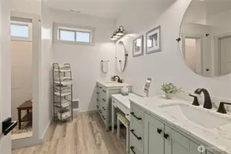 The primary suite features a double vanity and a beautifully finished tile walk-in shower, creating a functional and refined private retreat.