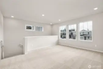 Spacious upstairs loft with large windows for natural light. Photos are representative only and may display different color packages and/or upgrades.