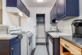 Lovely kitchen with new flooring and laundry hookup area in the back. (there are light colored tile floors underneath if you prefer something warmer too)