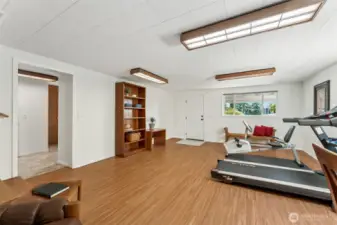 The family room space also has an exterior door to 2 car covered carport and the doorway to your left leads to a half bath and huge laundry room/storage area!