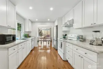 You'll love creating creating culinary delights in your bright kitchen with beautiful new, white shaker cabinets, granite counters, subway backsplash & those gorgeous hardwoods. Dine in or "al fresco" in the summer sun!