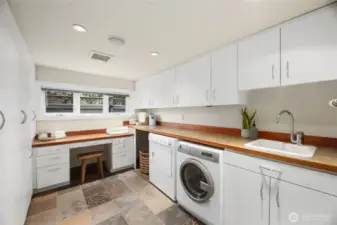 The lower-level laundry room with a ton of built-in cabinets to store all your things.