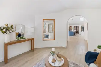Looking from the living room into the kitchen. The window shows a view of the front porch.