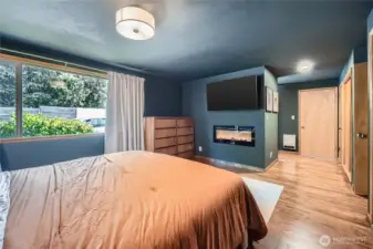 Step into the serene primary suite featuring a cozy fireplace, walk-in closet, and generous natural light through large picture windows. Thoughtfully designed with comfort in mind, this spacious retreat offers the perfect blend of style and relaxation—your personal haven at the end of the day.
