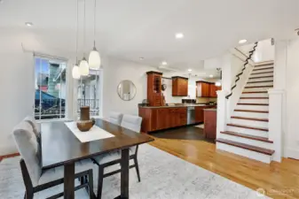 Wide staircase leads upstairs. Timeless kitchen with natural wood cabinets. Stainless steel appliances.