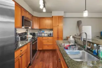 Galley kitchen with granite Counter, eating bar, SS appliances