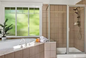 A large walk-in shower with elegant tile surround adds functionality and style.