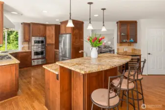 Beverage refrigerator and pantry located in between the dining room and kitchen.