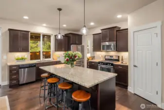 Quality finishes grace the kitchen with gas range and walk in pantry.