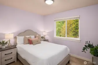 2nd bedroom with views of patio and green belt.