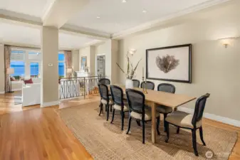 A dedicated and open-plan dining space featuring a clear sightline to the expansive Puget Sound and Olympic Mountains views.