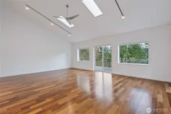 Great Room skylights (2), ceiling fan, track lighting. Sliding glass door to deck.
