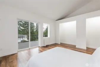 Primary Bedroom: two extra-tall closet spaces with inside lighting. Additional storage space above closet areas. Morning lake views.