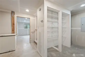 Lower level bonus / entry area (at bottom of stairs from interior entrance and outside bedroom # 1): spacious storage shelf and easy-access door to clean crawl space.