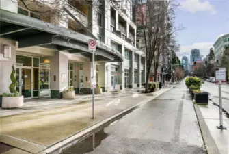 Designated bike lane separating 2nd Ave from sidewalk, right in front of condo building