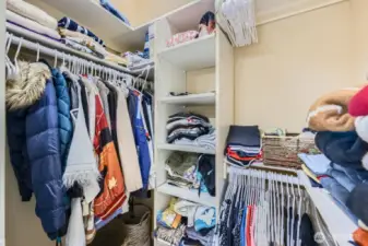 Primary walk-in closet with organizers.