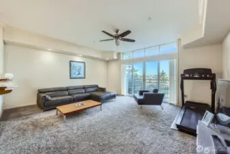 Bright and spacious living room with crown moulding detail and transom windows.