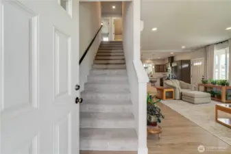 Entryway takes you up the wide staircase or into the main living area