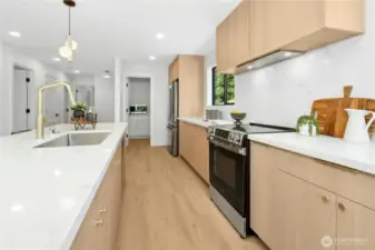 This view is looking towards a very roomy pantry with plenty of built-in cabinetry.