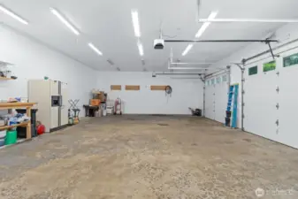 Large, oversized garage has bolts already drilled for a car lift.
