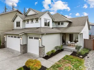 Front of 2 story craftsman home, picturesque neighborhood with No HOA! 3 car garage for more parking & storage