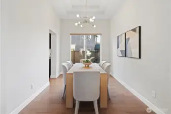 Formal dining room with coffered ceilings and beautiful chandelier
