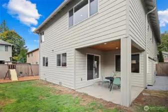 Backyard with covered entertaining patio and play structure