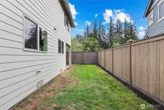 Backyard with covered entertaining patio and play structure