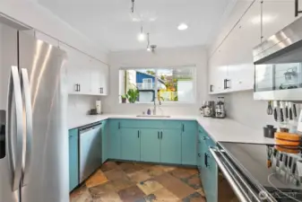 Updated kitchen includes new countertops, sink & faucet, appliances, and painted cabinets