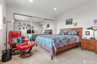 Main bedroom with lots of closet space behind the mirror