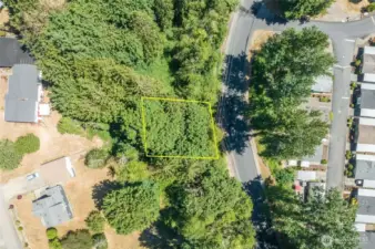 Aerial, behind single family homes and accessible maintained roadway.