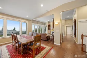 The wall of windows and doors onto the expansive deck, bring the views inside the home as well as so much natural sunlight. There are remote controlled shades in the dining room, and curtains in the living room.