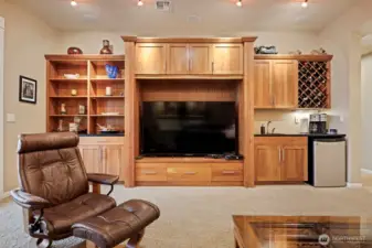 The built-in entertainment center matches that of all the cabinets throughout the home and has abundant storage.