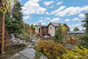 There is a gazebo to the left with a sitting bench to take in the views with the sounds of the waterfall in this private "oasis". There are also two varieties of Asian pear trees.