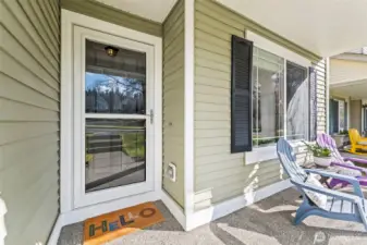 The inviting front porch faces a community greenspace.