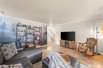 The mural is modern peel and stick wallpaper for easy removal, and the wall underneath is painted the same neutral color as the rest of the living room.