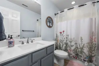 Upstairs hallway bathroom with a single vanity and tub/shower.