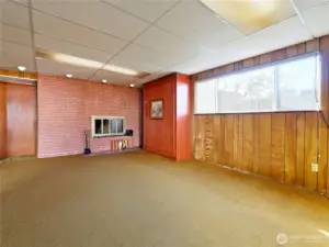 Rec room with wood fireplace and Murphy bed.