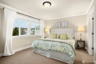 Primary Suite with large picture window and walk-in closet