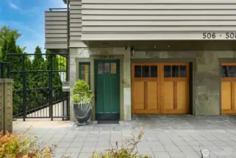 Entry with attached garage and off-street parking for 2 cars. A modest entry belies the unique interior!