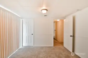 3rd bedroom with walk-in-closet at rear of home and french doors to the patio