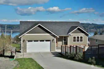 This 2019 one level home is positioned in a way that maximizes your view. 2 car garage. Three windows to the right belong to the 2nd bedroom.