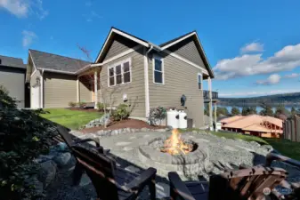 Low maintenance yard with sweet fire pit positioned to take in that view.