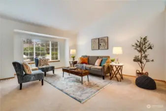 Flooded with natural light, the living room features a large, sunny window that allows the sun to shine through, creating a bright and cheerful atmosphere.