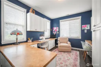 Custom built-in cabinets and desk tops provide an abundance of work space and storage.