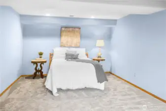 Alternate View of the Lower-Level Bedroom Retreat: A generous, inviting space with a cozy sitting area—ideal for unwinding, reading, or enjoying a quiet moment in comfort.