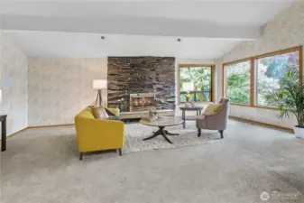 Generously Proportioned Living Room: A bright and airy space offering captivating views of vibrant, lush rhododendrons framed against the majestic backdrop of the Cascade Mountains—bringing nature’s beauty right into your home.