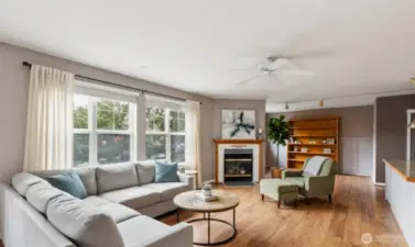 Virtually staged living room view from den and bedroom areas.